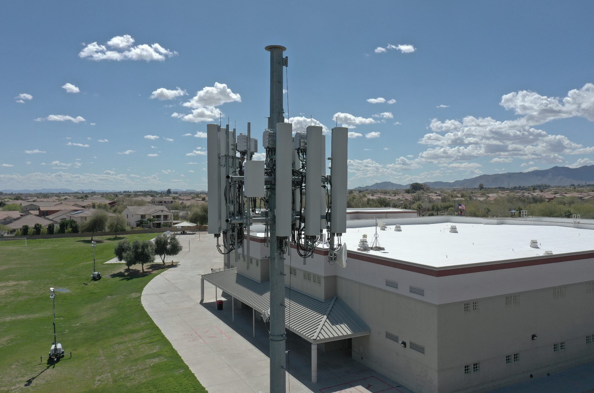 Drone photo of a cell tower and commercial rooftop during a vertical asset inspection