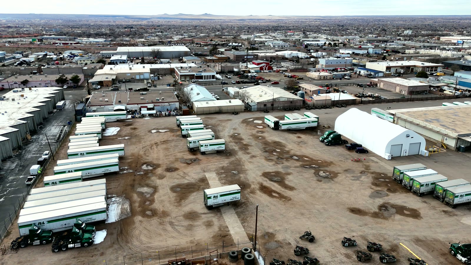 Aerial sweep over an Albuquerque logistics yard during a video shoot