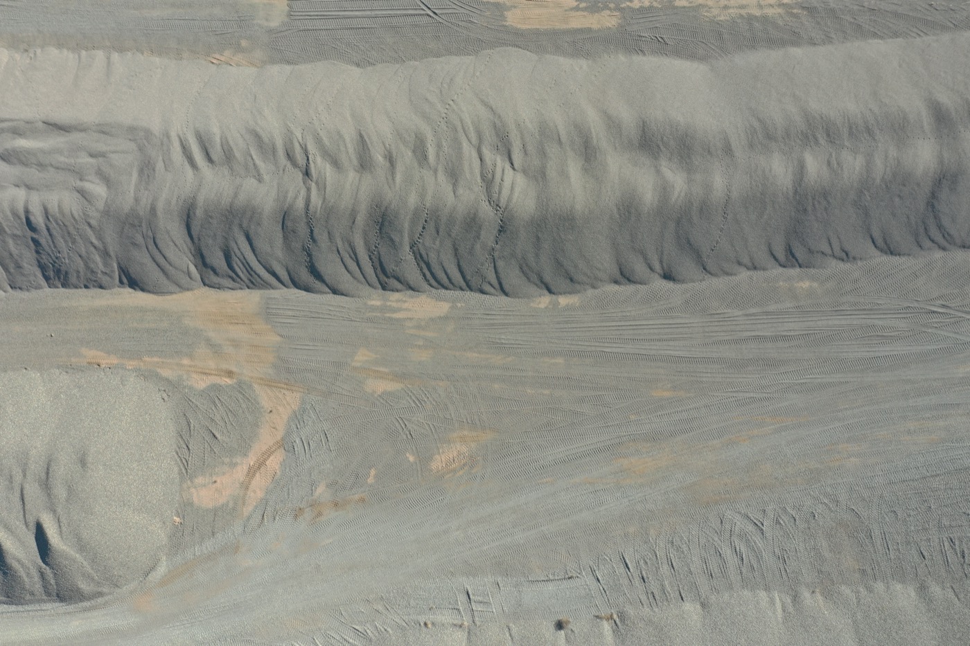 Top-down aerial of graded aggregate stockpiles at an Arizona sand and gravel operation