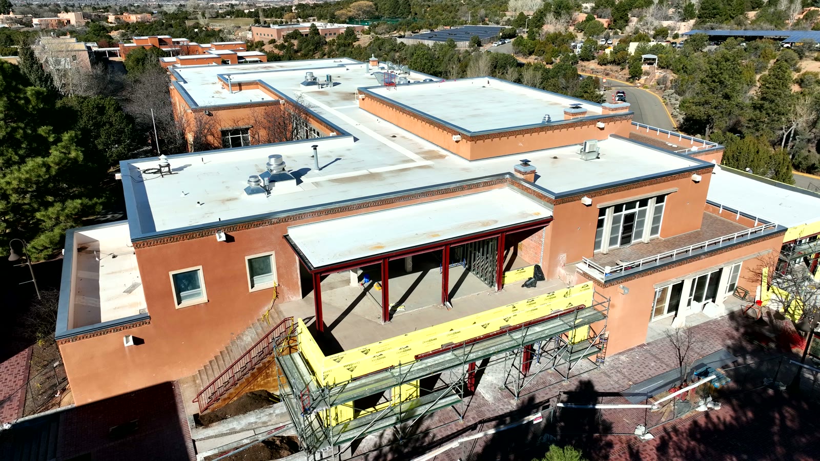 Low aerial pass along a Santa Fe campus building during a drone video shoot
