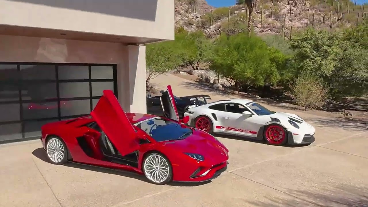 FPV still of a luxury home reveal with exotic cars