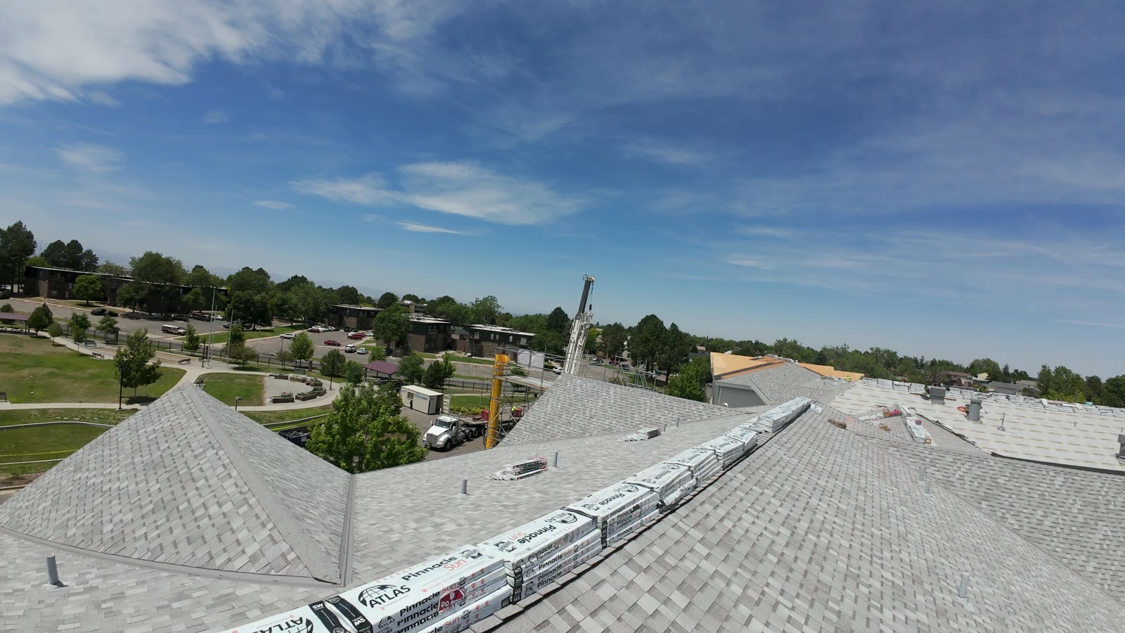 FPV drone frame skimming a rooftop ridgeline in the Denver metro