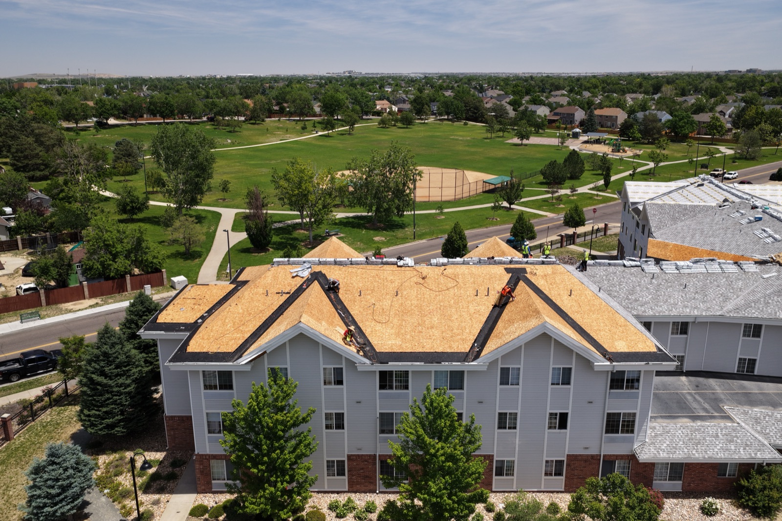 Aerial drone photo of a Denver metro property beside a park and ballfields