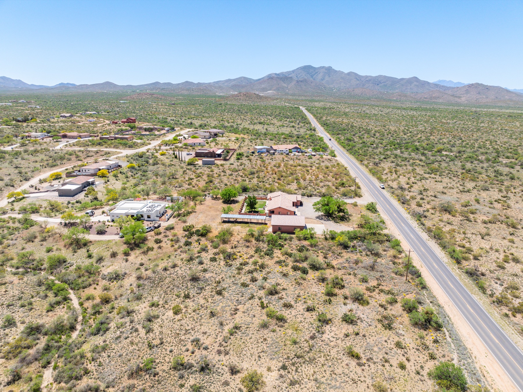 Aerial front elevation of a desert Southwest home with mountain backdrop