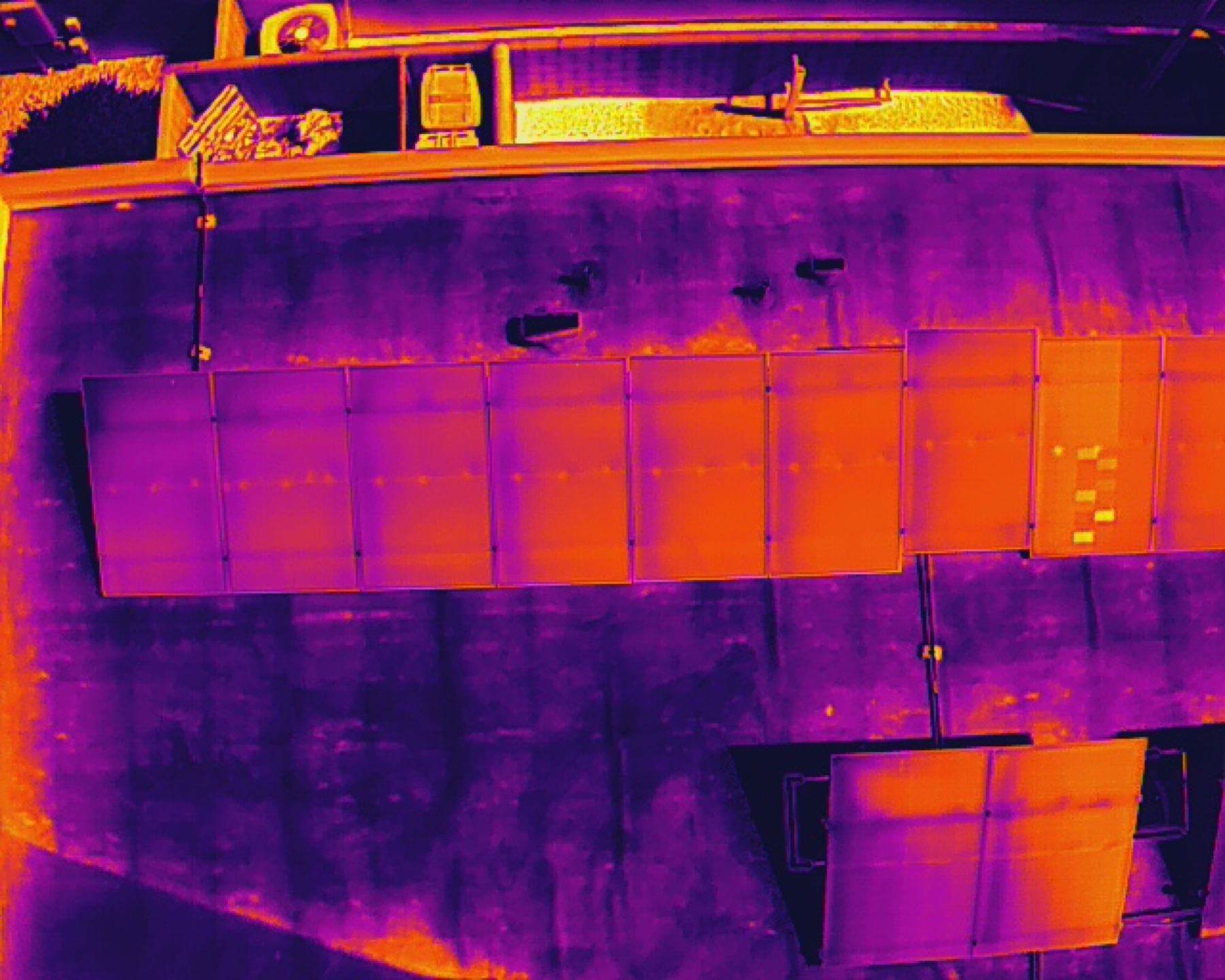 Close aerial detail of solar panels showing thermal anomalies