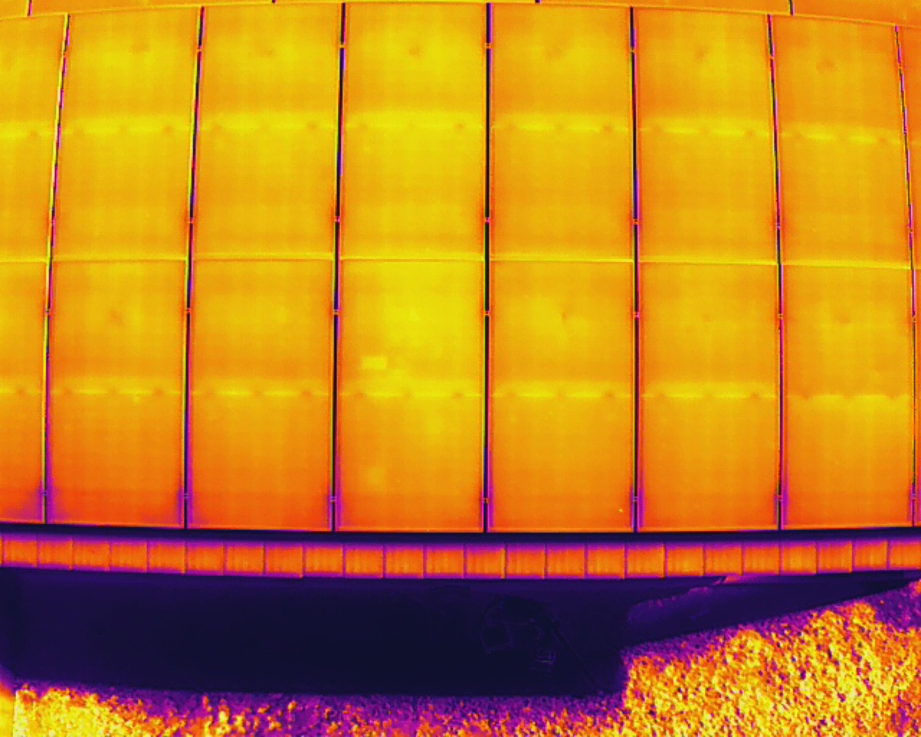 Aerial view along rows of a ground-mount solar installation