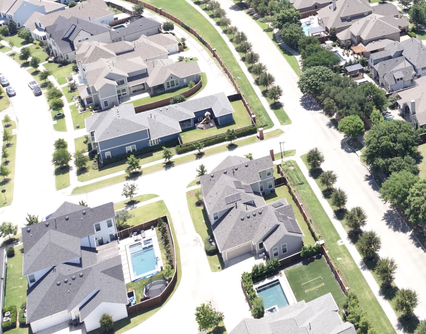 Aerial of Frisco homes with pools and landscaped lots