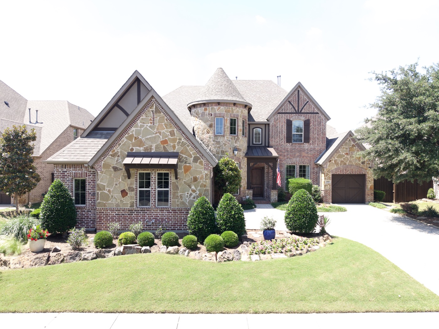 Aerial front elevation of a luxury brick and stone home in Frisco, Texas