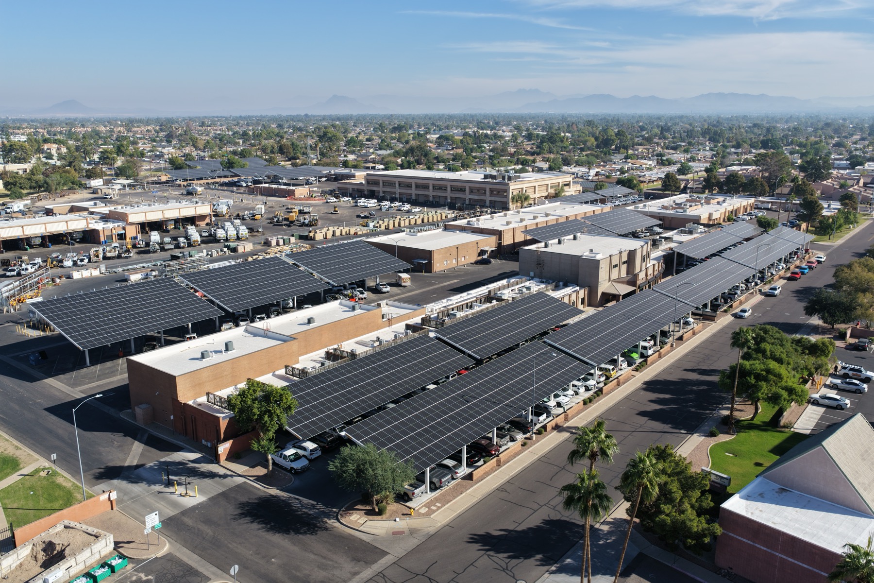 Aerial of large solar carport canopy arrays over a municipal lot in Mesa, Arizona