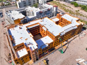 Aerial drone photo of a multifamily construction site with roofing membrane installation