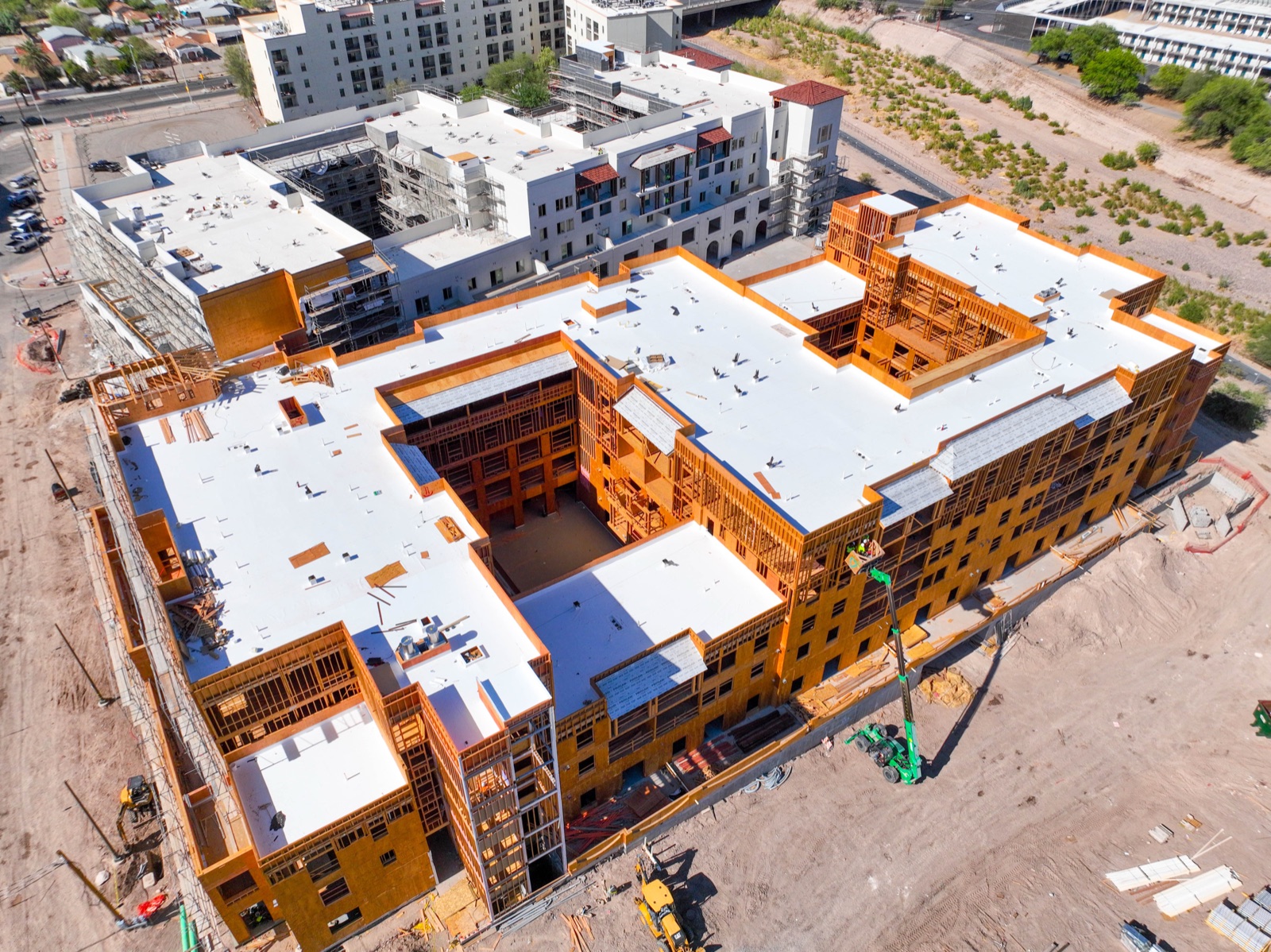 Aerial drone photo of a multifamily construction site with roofing membrane installation