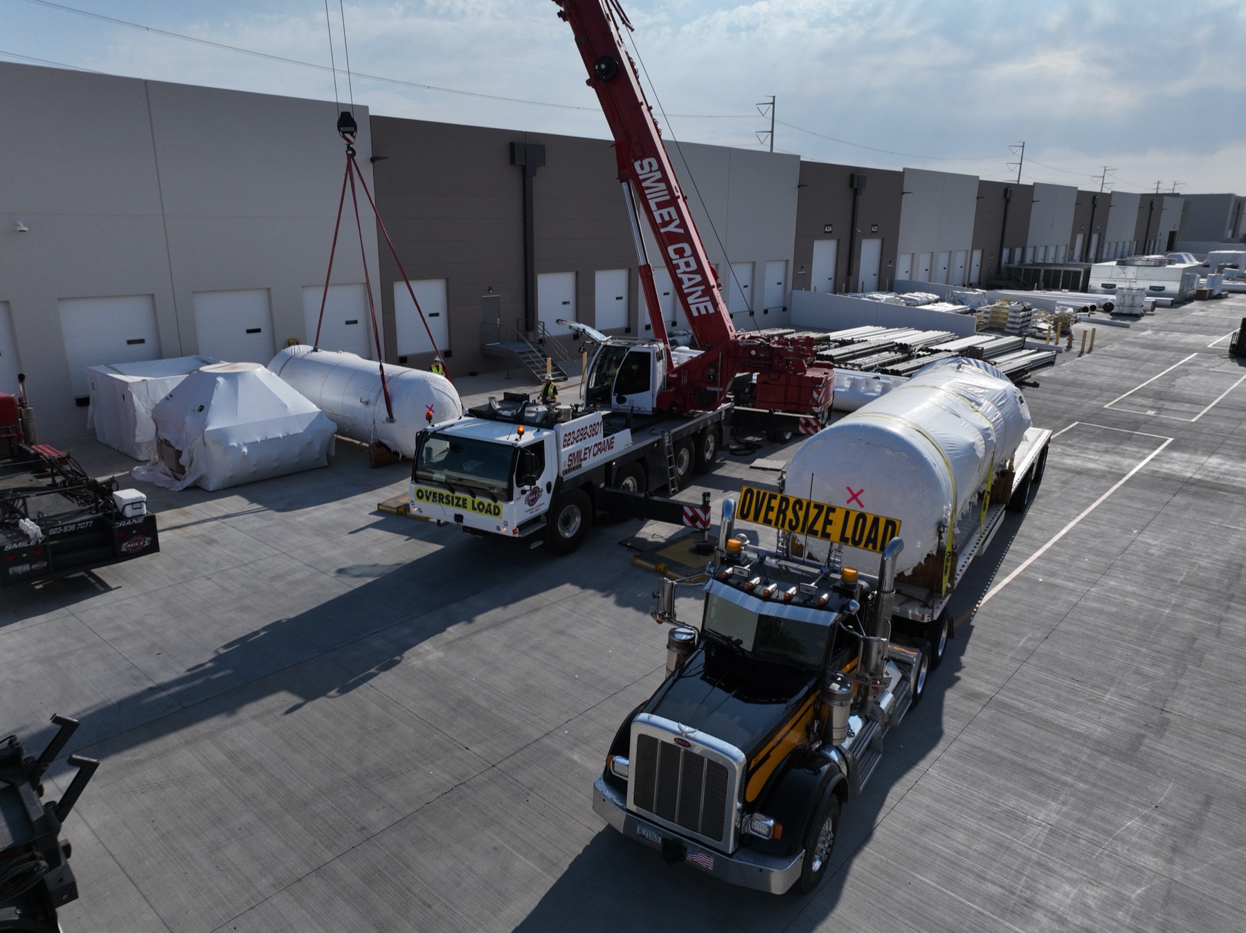 Aerial of a logistics yard with a crane lift in progress in Phoenix