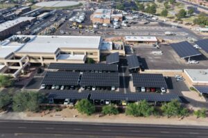 Aerial of commercial solar carport canopies over a fleet lot, Phoenix metro