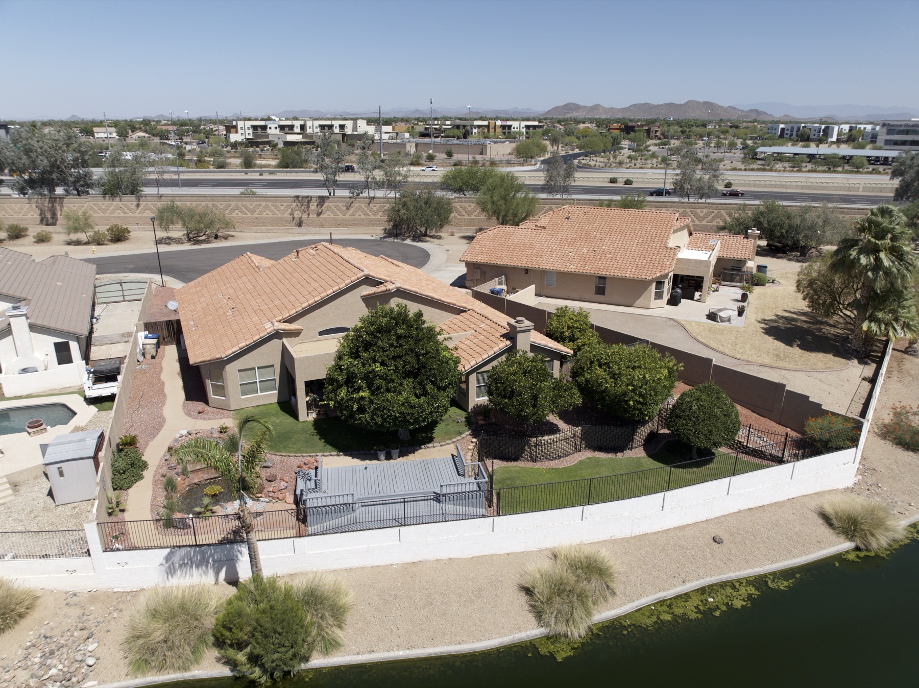 Aerial of a Valley tile-roof home with pool and backyard