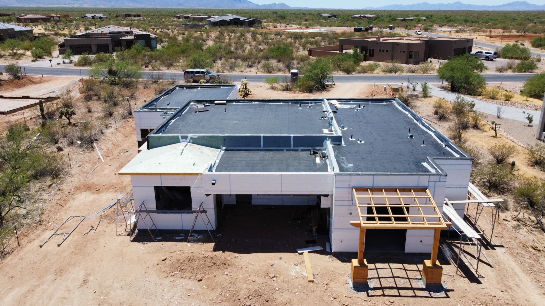 Aerial view of a custom desert home under construction in the Tucson metro at masonry stage