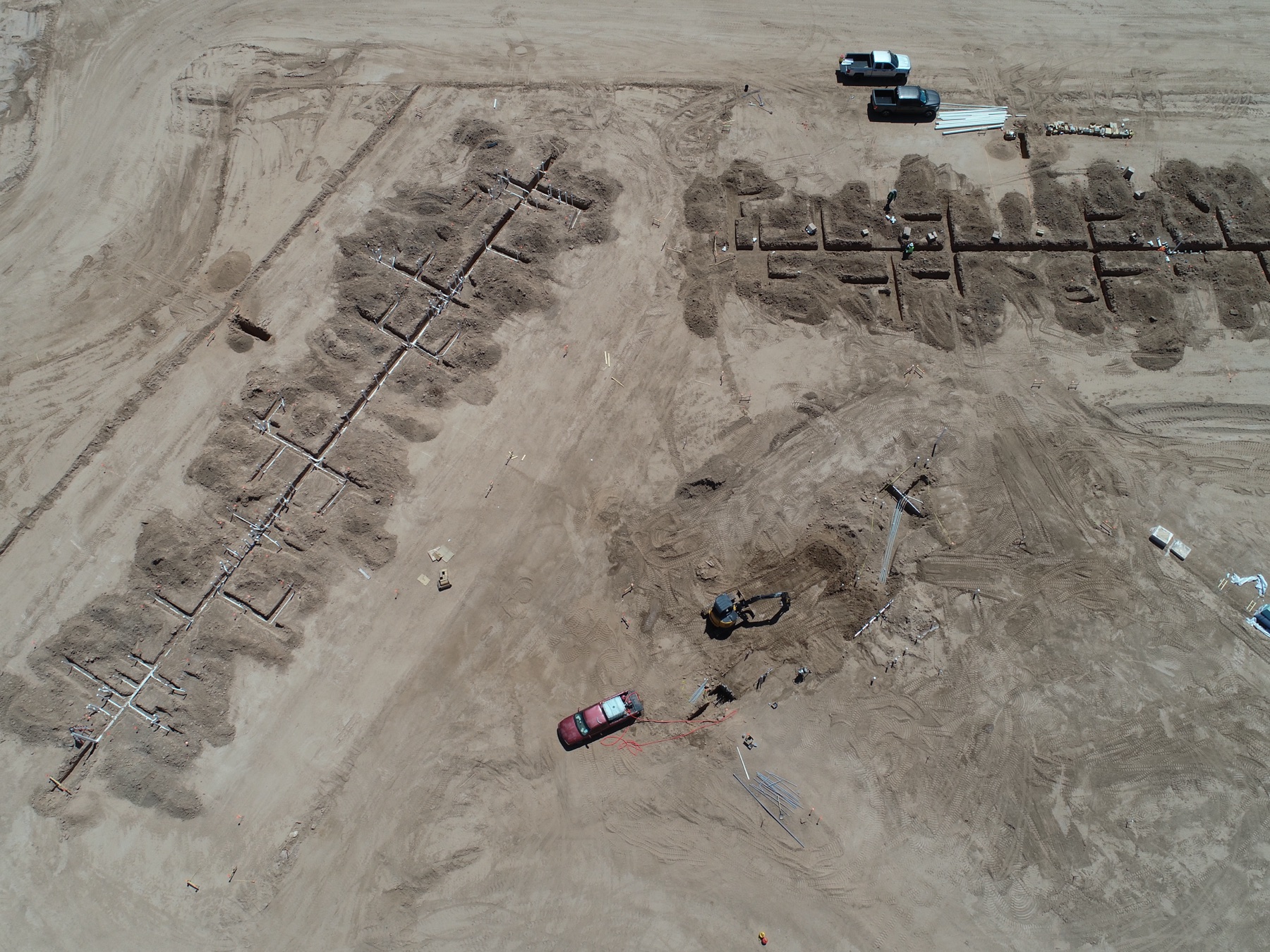Top-down aerial of foundations and utilities at a Marana master-planned community