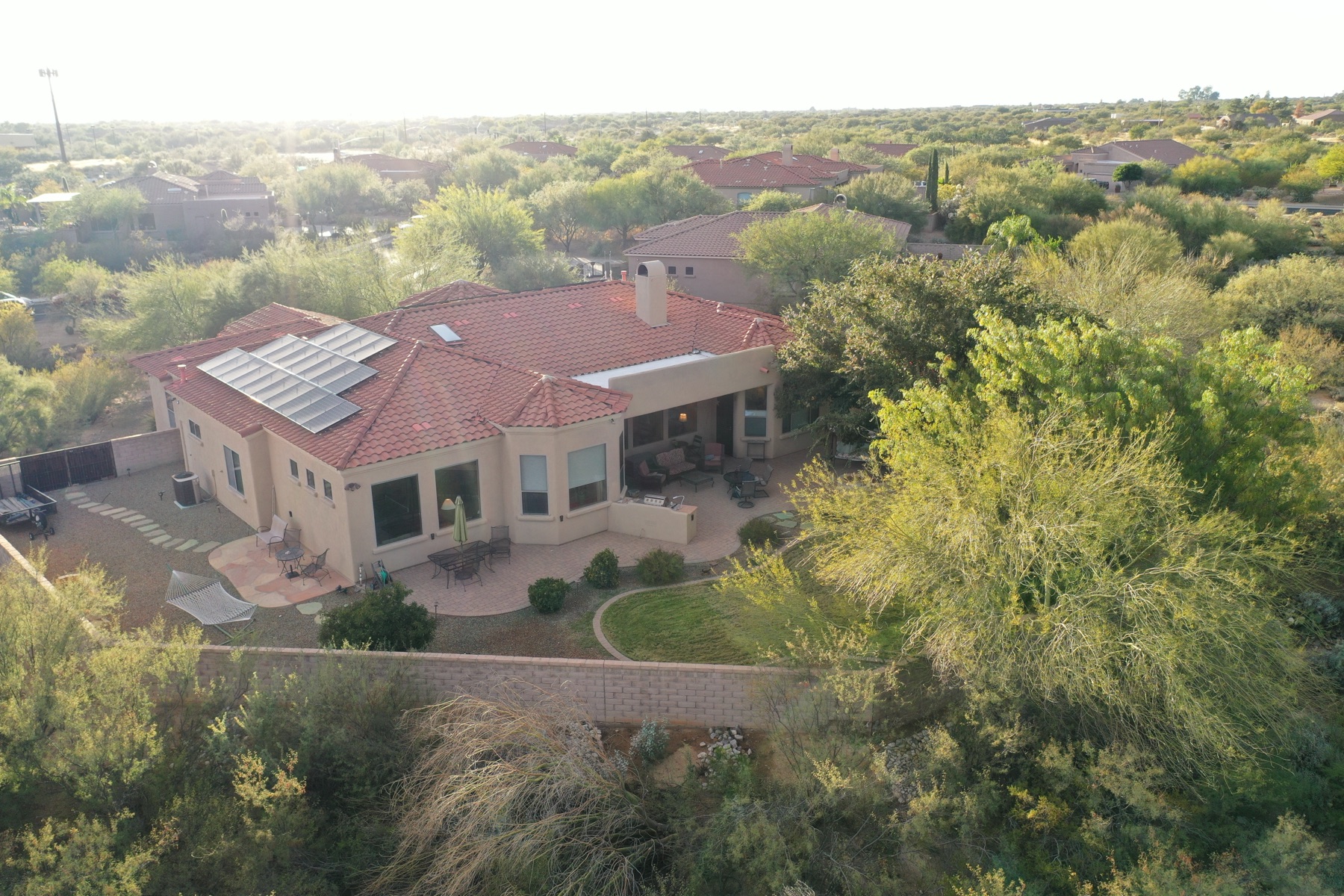 Aerial view of an Oro Valley luxury home with tile roof and mountain backdrop