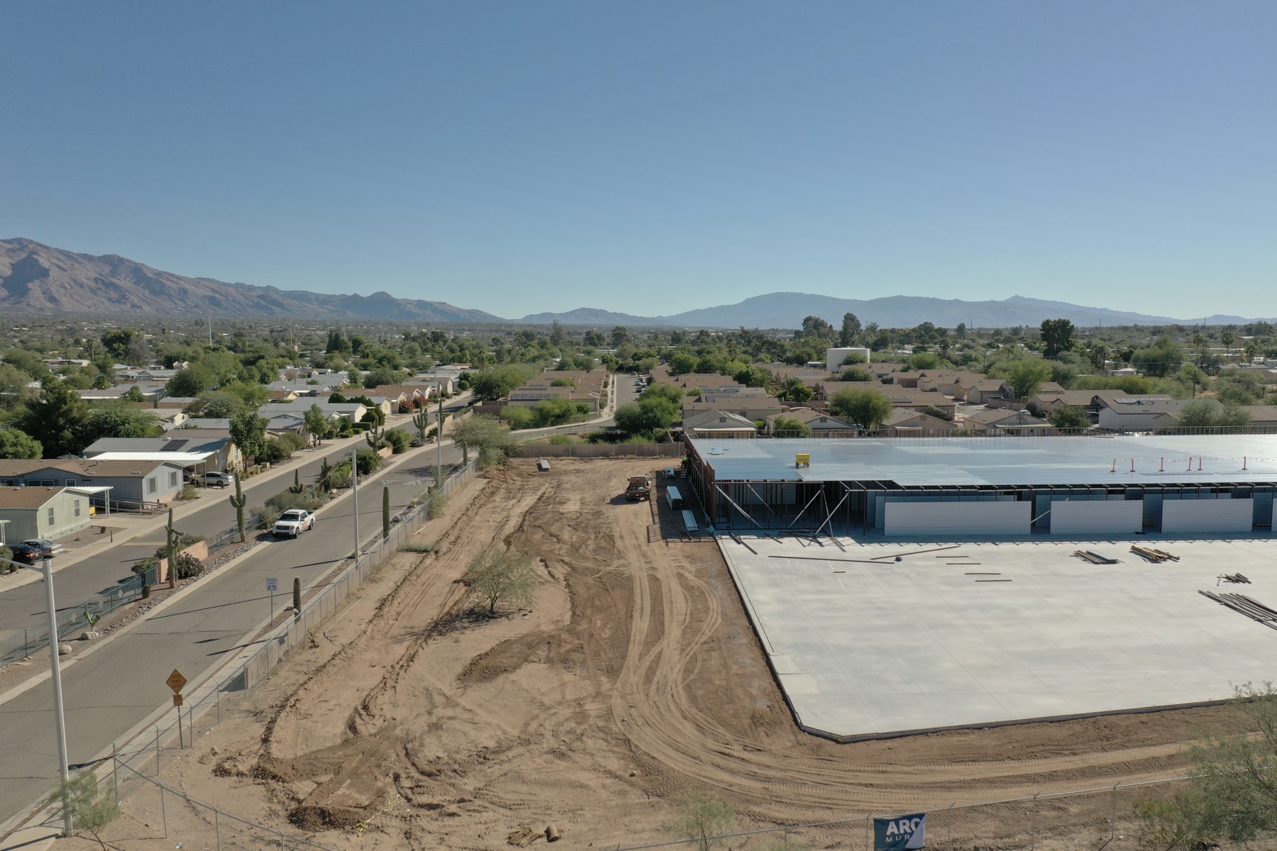 Aerial view of site grading and fresh slab at a Tucson self-storage development on Ruthrauff Road