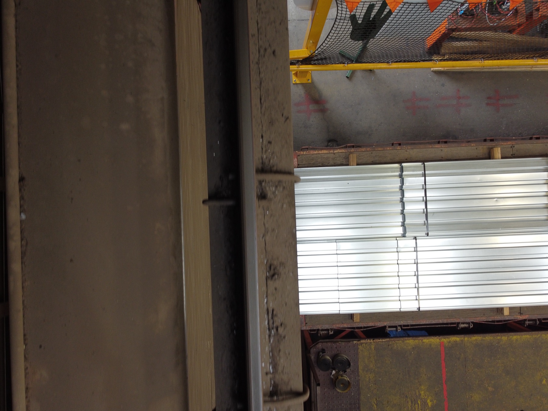 Drone inspection photo along a crane runway beam inside an operating steel-decking plant in Glendale, Arizona